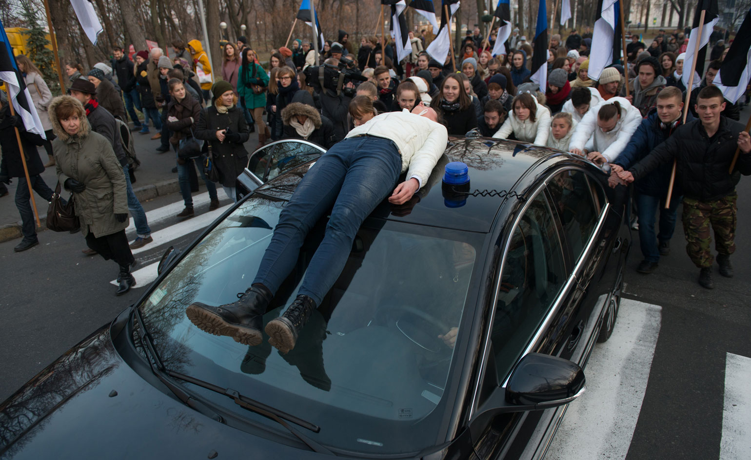 Person laying on roof of vehicle