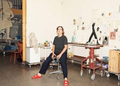 Klara Kristalova in her studio. Behind are sketches and works in progress. 