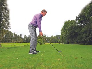 Keith Wood demonstrating alignment with sticks on the ground at set-up in the golf swing