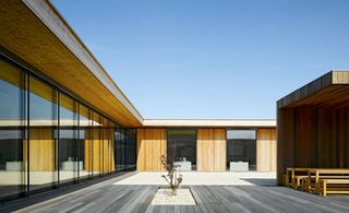 Wooden L shaped building and courtyard