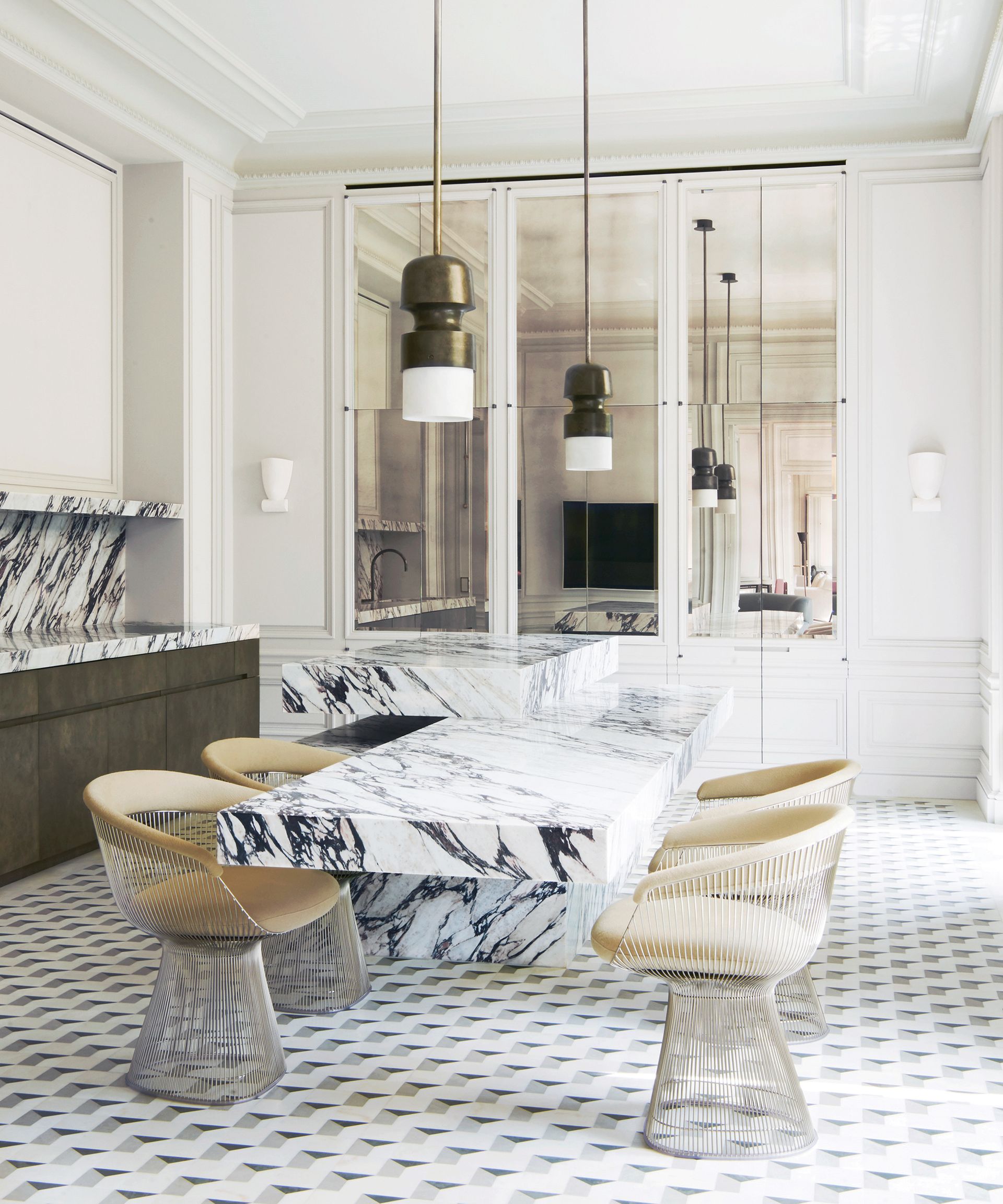 Modern white kitchen with marble backsplash and table