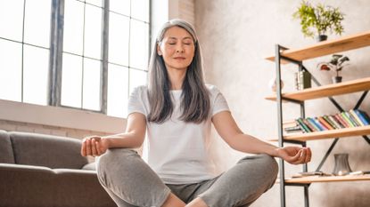 Woman sitting in meditative posture.