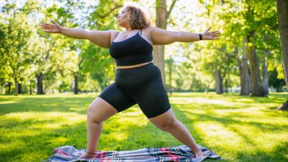 Woman practices yoga outside