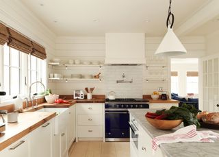 Modern white kitchen with wooden worktops and kitchen island