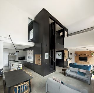 open plan kitchen, living and dining space with black staircase