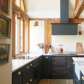 country kitchen ideas, country style kitchen with dark grey units, white worktops, Everhot range, beams, off white walls, sink in island