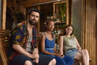 Steve (David Mumeni), Carrie (Patricia Allison) and Daisy (Imogen King) are seated in a row, with the laboratory at Healing Skin visible behind them.