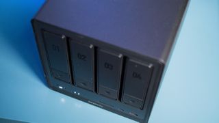 UGREEN DXP4800 Pro 4-bay NAS on a side table showing drive bays