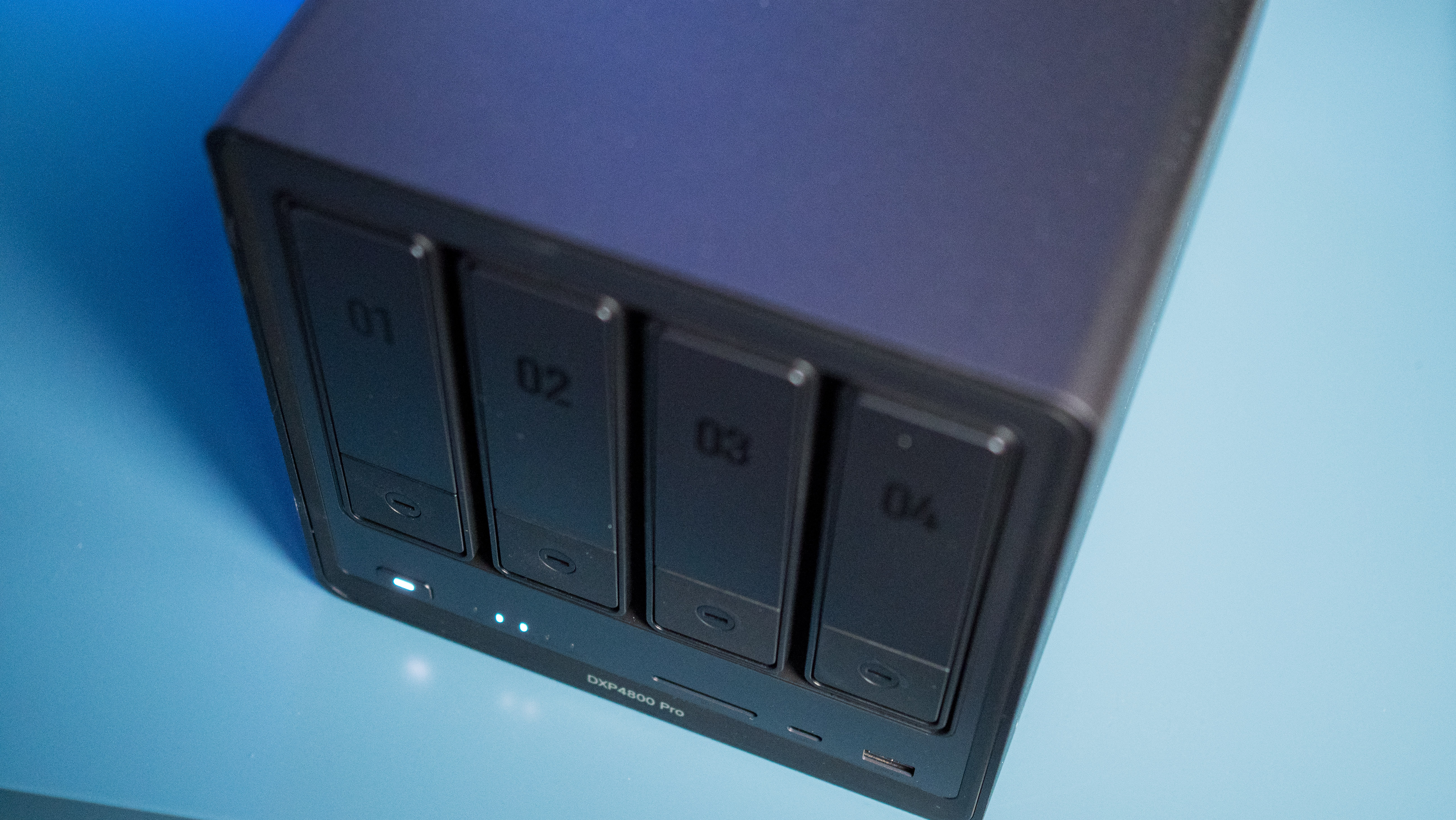 UGREEN DXP4800 Pro 4-bay NAS on a side table showing drive bays