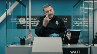 Alex Lifeson as a US immigration officer