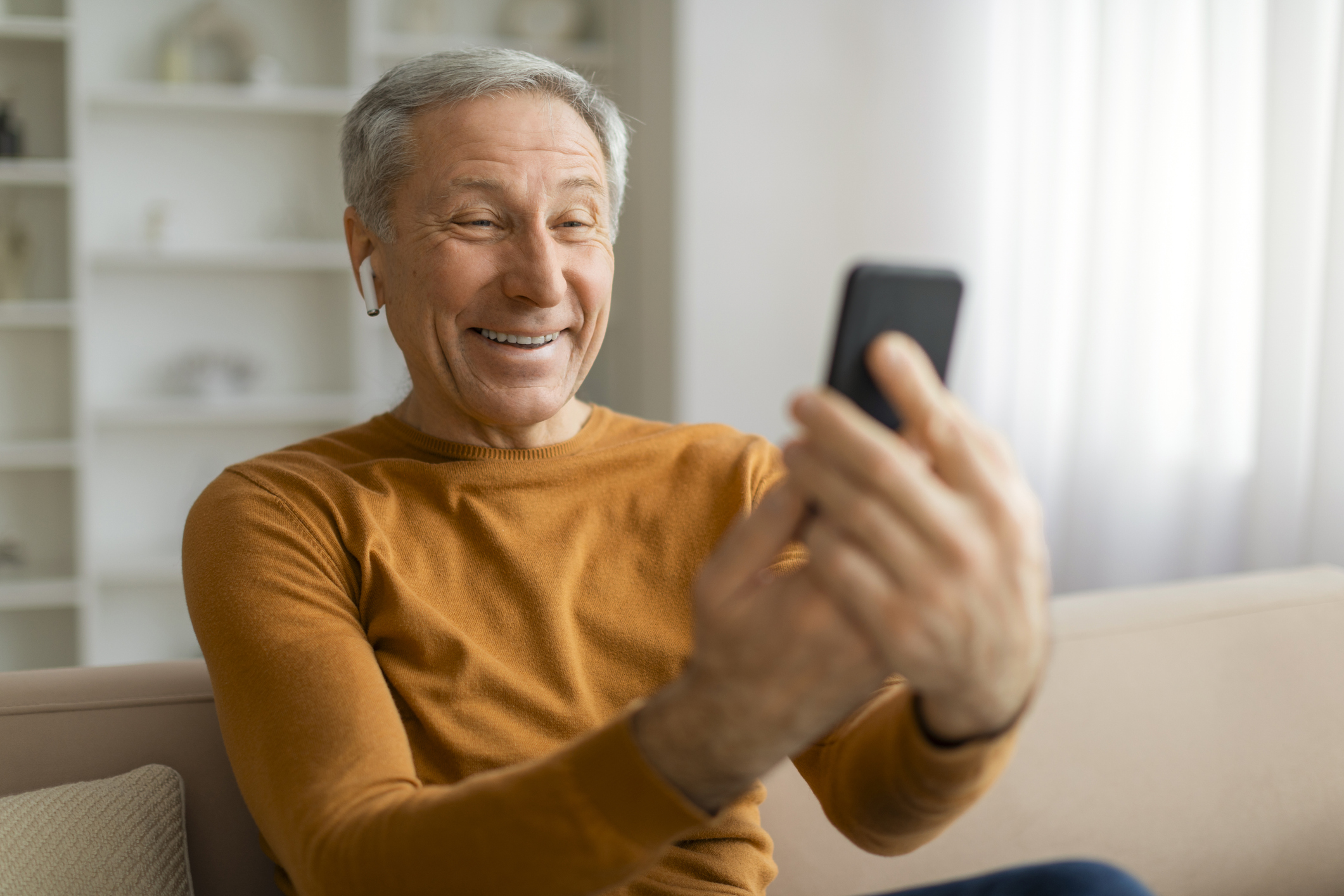 A man using his smartphone to video chat 