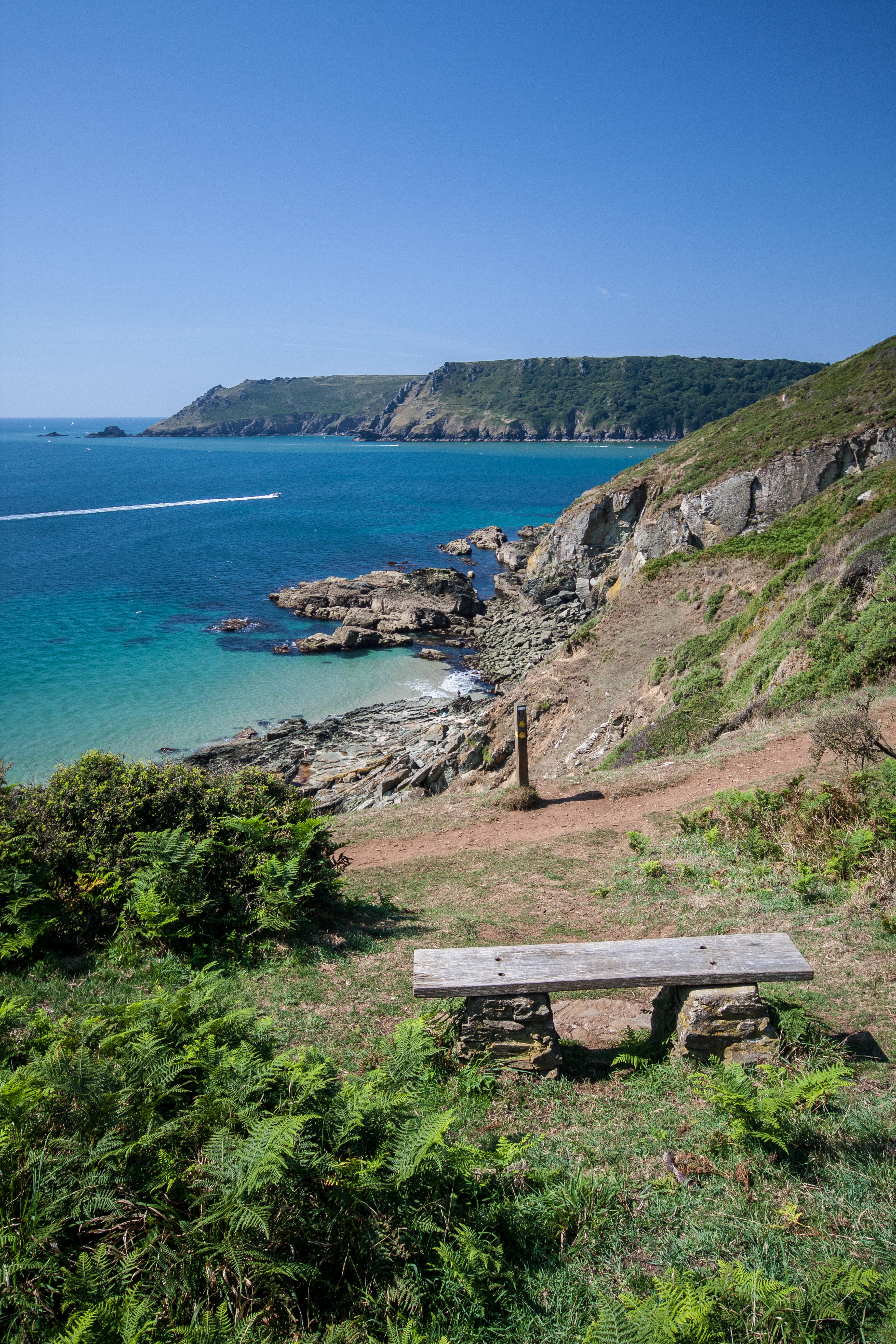 A wooden bench on the South West Coast Path