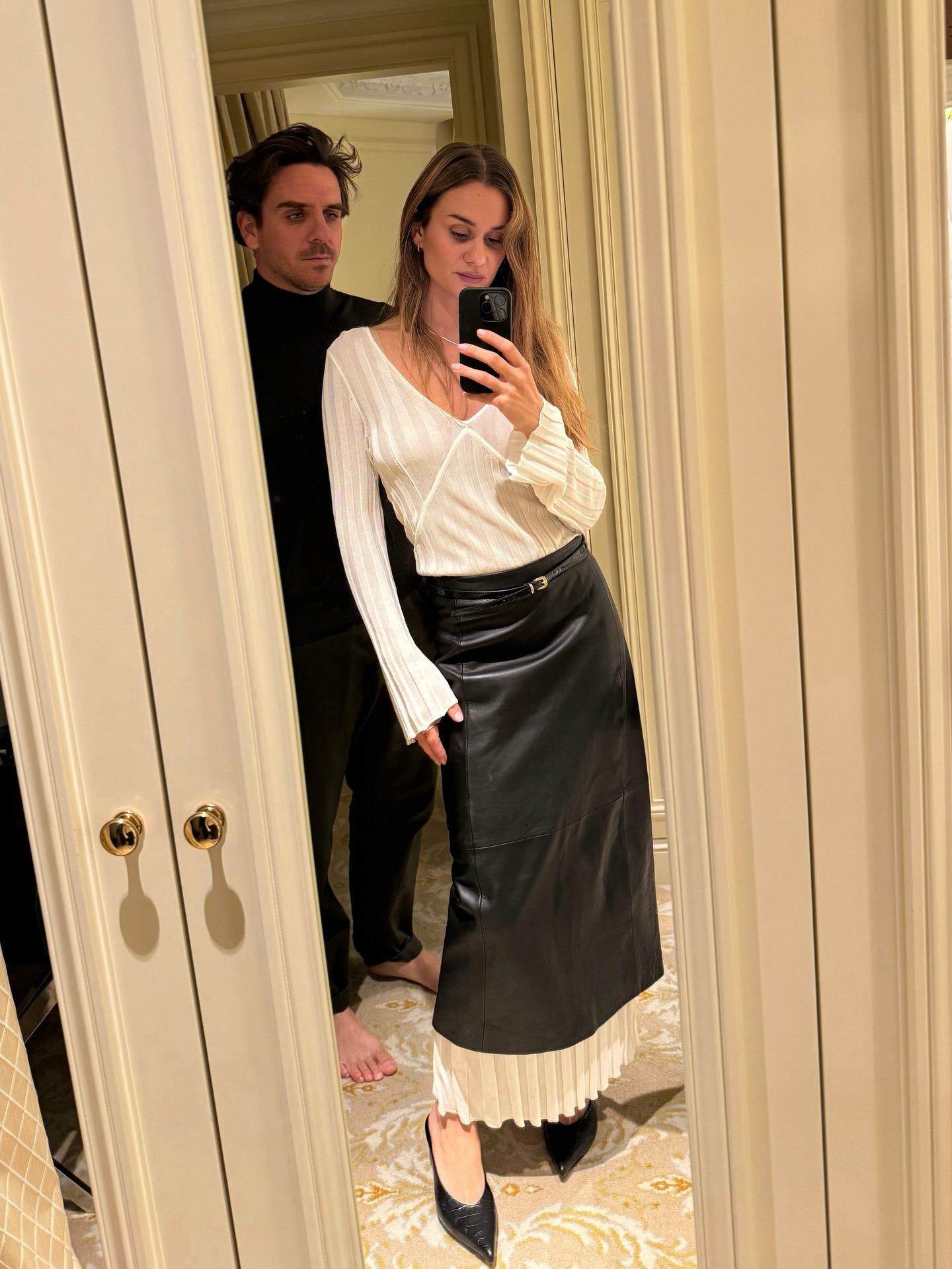 Woman wearing a leather skirt.