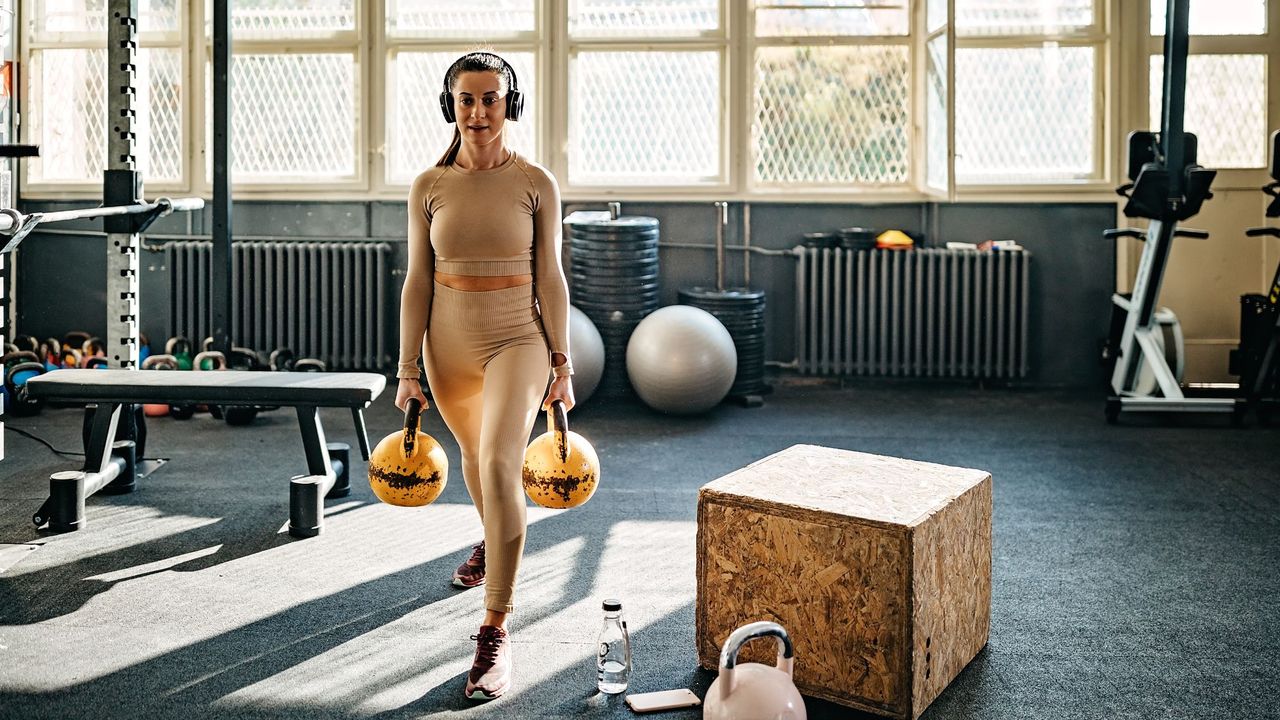 Kettlebell exercises being done by a woman at the gym