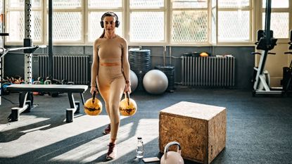 Kettlebell exercises being carried out by a woman in the gym