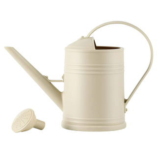 An ivory colored watering can