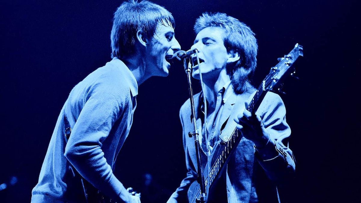 Paul Weller and Bruce Foxton performing live onstage, singing at same microphone, Wembley Arena, December 1982