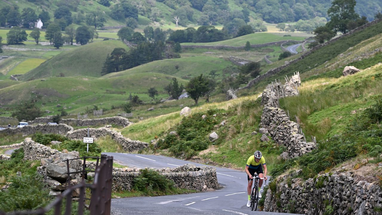 Rider climbs out the saddle in summer kit