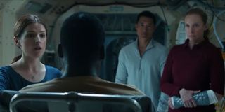 Anna Kendrick, Daniel Dae Kim, and Toni Collette circle around Shamier Anderson in Stowaway.
