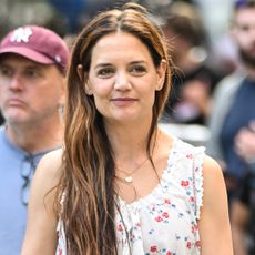 Katie Holmes walking in manhattan wearing a doen top and a fall boot trend
