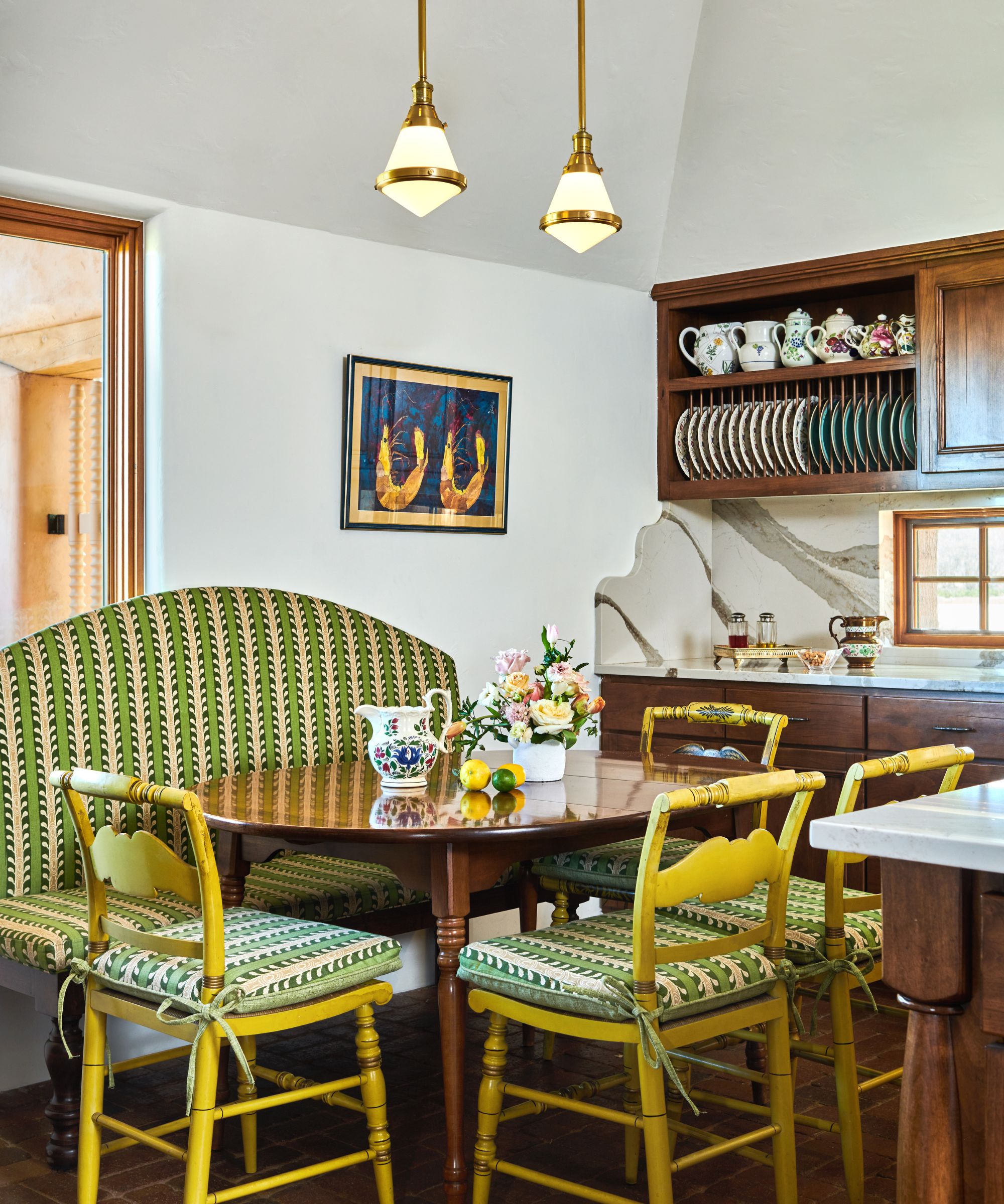 A wooden kitchen with marble countertops, backsplash, and sidesplash