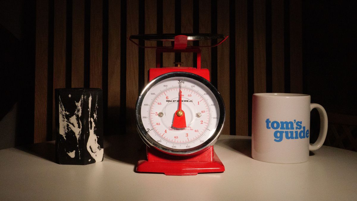 A photo of a set of red scales next to a Tom's Guide mug
