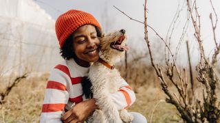 Woman cuddling her dog