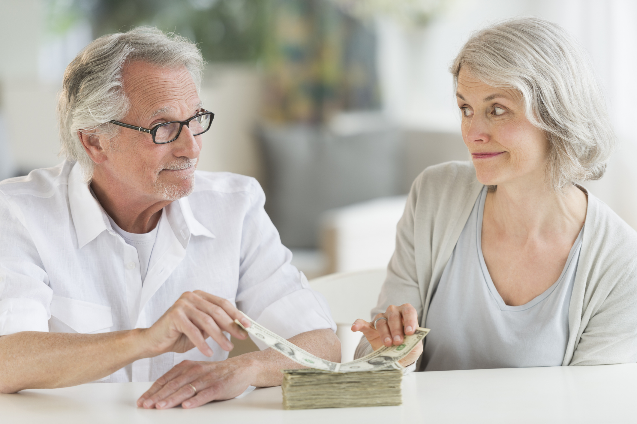 couple taking money off a stack 