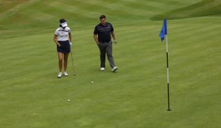 Georgia and Matt walk up on to the green