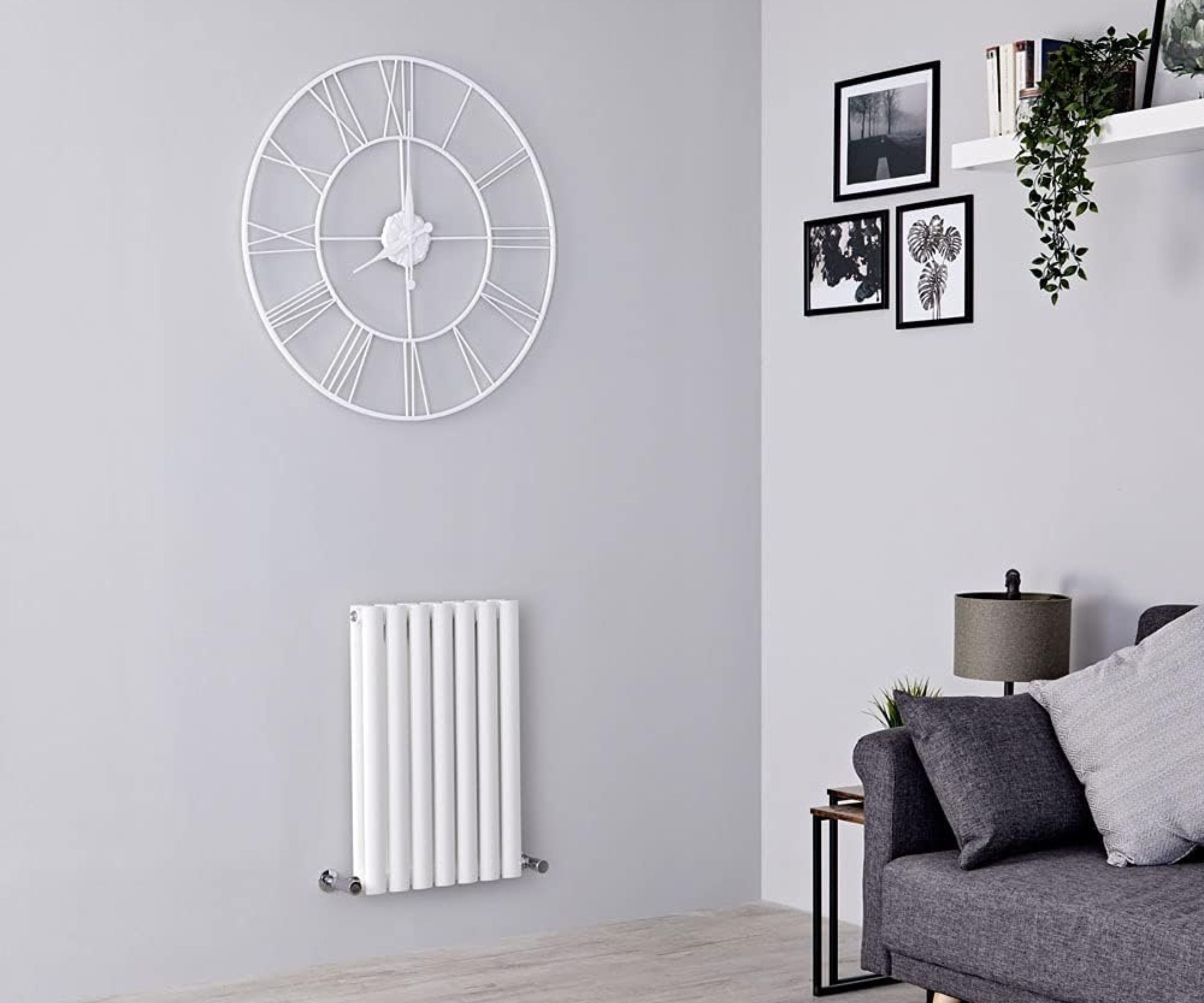 Milano Aruba White Horizontal Double Oval Panel Radiator fixed to grey coloured wall underneath a clock