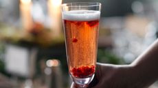 Christmas cocktail in a flute with pomegranates