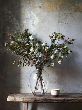 Christmas flower arrangement with holly and berries by Neptune