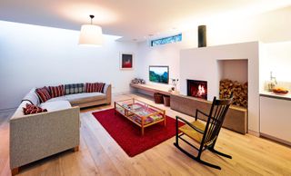 living room in light-filled contemporary home with clerestory window and fireplace