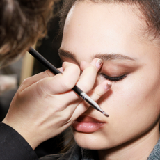 best eyeshadow primer - make-up artist applying eye make-up to a model