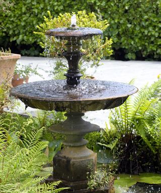 stone water fountain in garden