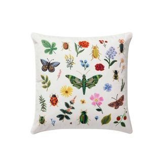 The Curio Embroidered Pillow with bugs and flowers scattered about