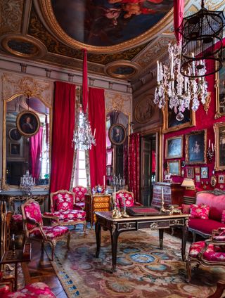 room with gold walls and tables, silk curtains and green wallpaper, items on auction at sotheby's paris, collected by jacques garcia