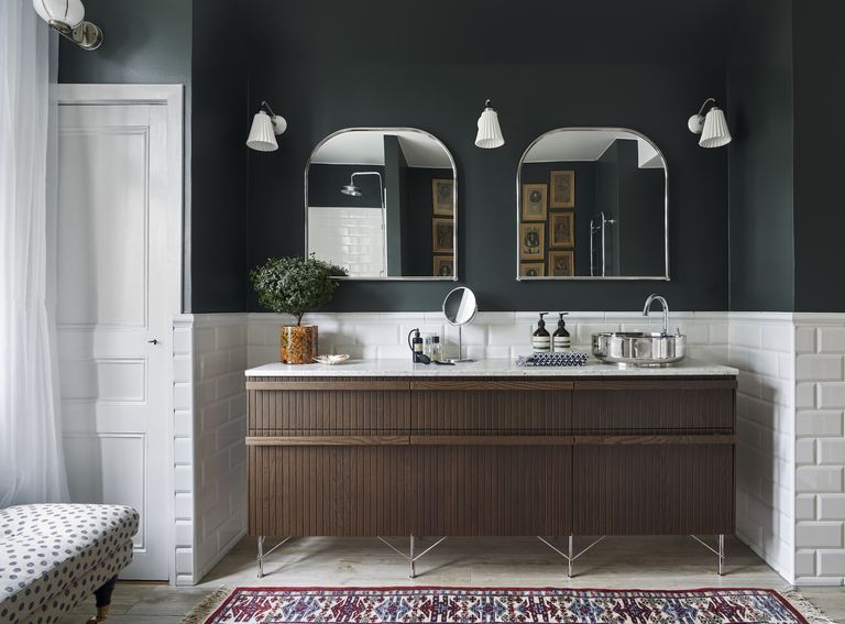 Ikea bathroom hacks with dark wood fluted vanity units and dark walls by Superfront