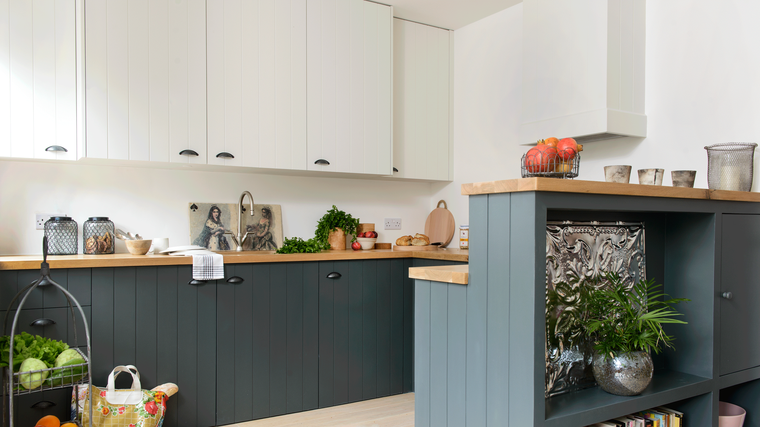 Dark green kitchen units with wooden worktop