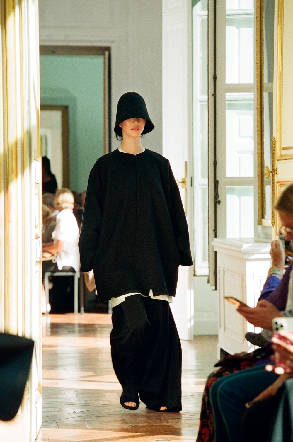 Model wearing black wool hat from The Row Spring Summer 2024 collection.
