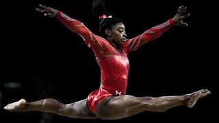 Gymnast Simone Biles mid-jump