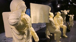The annual butter display at the 2019 Ohio State Fair honors the 50th anniversary of the first moon landing and includes sculptures of Neil Armstrong saluting the American flag next to the lunar module, the full Apollo 11 crew, the official Apollo 11 patch and the traditional butter cow and calf.