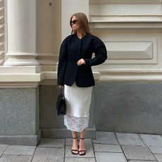 hana wears white slip skirt with lace and cinched blazer and black heels