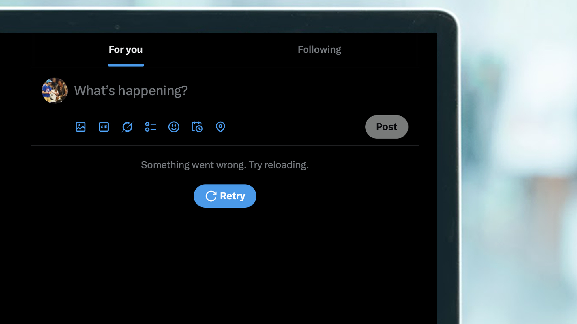 A laptop screen showing X being down