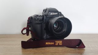 Nikon F5 - one of the best film cameras - sitting on a wooden surface