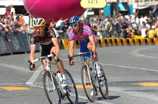 Jens Voigt (RadioShack-Nissan) and Danilo Hondo (Lampre-ISD) attempt to break away during the final stage at the Tour de France