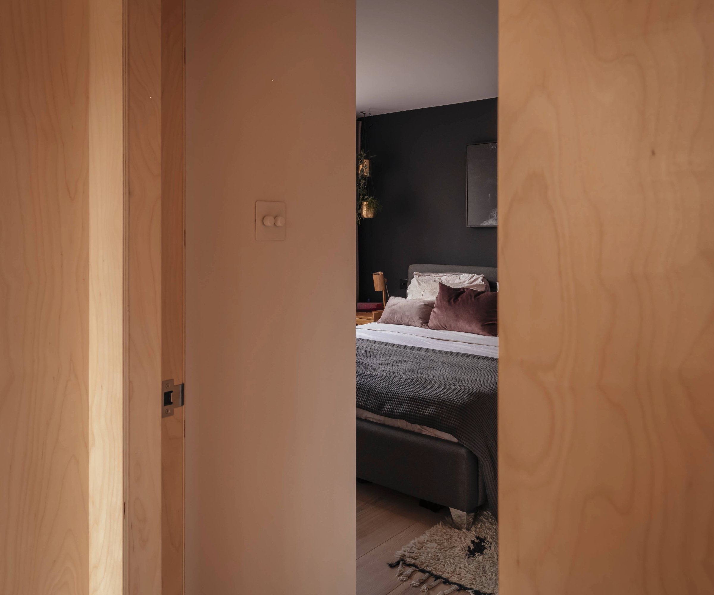 Glimpse through the bedroom through the wooden door