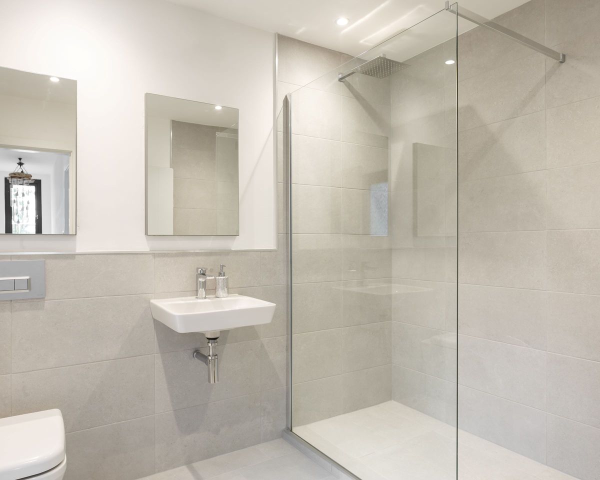 A white porcelain bathroom with a walk in shower
