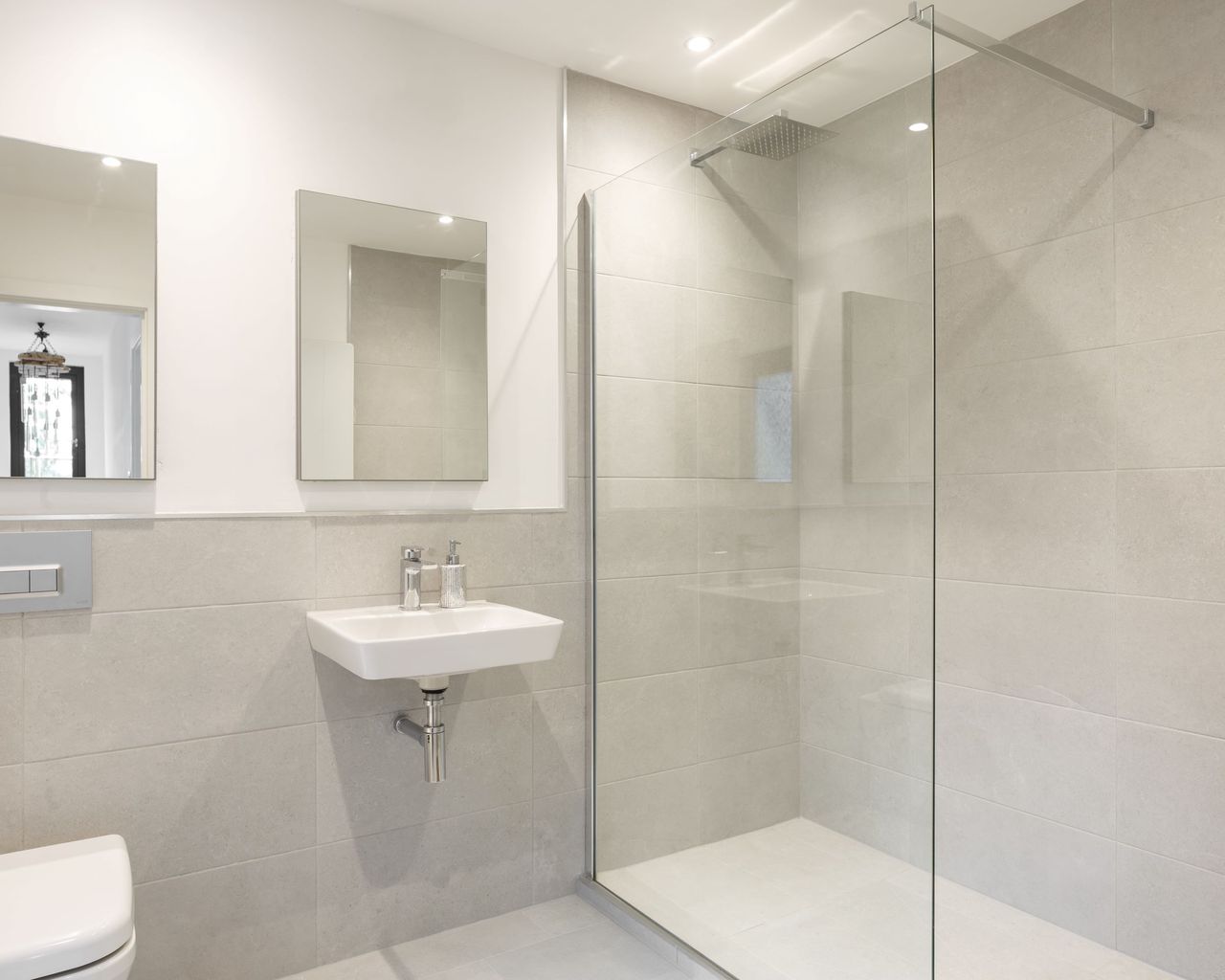 A white porcelain bathroom with a walk in shower