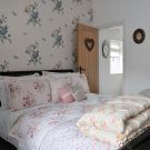 bedroom with wallpaper and cushion